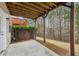 Covered back patio with wood ceiling offers an outdoor space near a fenced backyard with mature trees at 4662 Creekside Villas Se Way, Smyrna, GA 30082