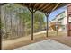 Wood beam patio near the backyard lawn with trees, plus the exterior decks of nearby homes are visible at 4662 Creekside Villas Se Way, Smyrna, GA 30082