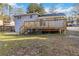 Backyard featuring a wooden deck with stairs leading down to the lawn at 8331 Attica Ct, Jonesboro, GA 30238