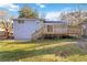 Home's backyard features a deck, grassy yard, and partial fence at 8331 Attica Ct, Jonesboro, GA 30238