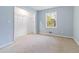 A simple bedroom with blue walls and a built in closet at 8331 Attica Ct, Jonesboro, GA 30238