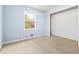 A basic bedroom with neutral carpet, and a window for natural light at 8331 Attica Ct, Jonesboro, GA 30238