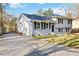 Split-level home featuring updated white paint, dark shutters, and a long driveway at 8331 Attica Ct, Jonesboro, GA 30238