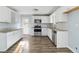 Modern kitchen featuring stainless steel appliances, granite countertops, and wood flooring at 8331 Attica Ct, Jonesboro, GA 30238