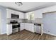 A modern kitchen features stainless appliances, white cabinets, and gray countertops at 8331 Attica Ct, Jonesboro, GA 30238