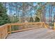 Wooden back deck with a view of the wooded backyard at 1117 Mountain Springs Nw Dr, Kennesaw, GA 30144