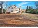 Large grassy backyard with a view of the back of the house and a wooden deck at 1117 Mountain Springs Nw Dr, Kennesaw, GA 30144