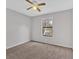 Cozy bedroom with a ceiling fan, a window that provides natural light, and neutral colored walls at 1117 Mountain Springs Nw Dr, Kennesaw, GA 30144