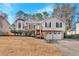 Exterior shot of a two-story home with a two-car garage and mature landscaping during the day at 1117 Mountain Springs Nw Dr, Kennesaw, GA 30144