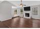 Bright living room featuring hardwood floors, a ceiling fan, and a cozy fireplace at 1117 Mountain Springs Nw Dr, Kennesaw, GA 30144