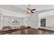 Open-concept living room featuring hardwood floors, a ceiling fan, and access to the kitchen at 1117 Mountain Springs Nw Dr, Kennesaw, GA 30144