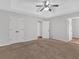 Large bedroom with tray ceilings, ceiling fan, double closet doors, and plush carpeting at 1117 Mountain Springs Nw Dr, Kennesaw, GA 30144