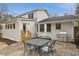 Backyard patio area complete with outdoor dining furniture, a grill, and access to the home at 1524 Chateau Dr, Dunwoody, GA 30338