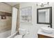 This newly renovated bathroom has a modern vanity, custom mirror, and a shower with beautiful stone detail at 1524 Chateau Dr, Dunwoody, GA 30338