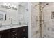 Modern bathroom featuring double vanity and tiled shower with decorative accents at 1524 Chateau Dr, Dunwoody, GA 30338