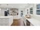 Contemporary kitchen with white cabinets, stone backsplash, stainless steel appliances, and wood floors at 1524 Chateau Dr, Dunwoody, GA 30338