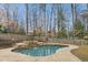 The backyard has a pool surrounded by lush landscaping, grass, and a wooden fence at 1524 Chateau Dr, Dunwoody, GA 30338