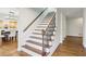 Elegant staircase with modern metal railing, hardwood steps, and natural light at 1524 Chateau Dr, Dunwoody, GA 30338