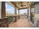 Cozy outdoor porch featuring stone accents, wooden flooring and views of the neighborhood at 170 Maple View Ct, Dallas, GA 30157