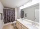 Bathroom with double sink vanity, large mirror, a shower-tub combination with a floral patterned curtain at 1935 Azure Grove Ct, Marietta, GA 30008