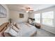 Bright bedroom featuring a ceiling fan and a dedicated workspace with natural light from two windows at 1935 Azure Grove Ct, Marietta, GA 30008