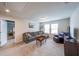 Cozy carpeted living room with a comfortable gray sectional sofa and a leather chair at 1935 Azure Grove Ct, Marietta, GA 30008