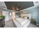 Spacious main bedroom features a decorative tray ceiling, fan, and ample space for relaxation at 1935 Azure Grove Ct, Marietta, GA 30008