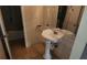 Cozy bathroom featuring pedestal sink, tile floor, and a separate toilet and shower area at 2722 Penwood Pl, Lithonia, GA 30058