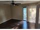 This bedroom features hard wood floors, a ceiling fan, and a sliding glass door to a balcony at 2722 Penwood Pl, Lithonia, GA 30058