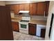 Kitchen featuring upper and lower wooden cabinets and white appliances at 2722 Penwood Pl, Lithonia, GA 30058