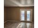 Bright room with tiled flooring and double doors leading to the exterior of the home at 2722 Penwood Pl, Lithonia, GA 30058