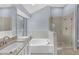 Bathroom featuring a soaking tub and a glass enclosed shower at 560 Woodstone Rd, Lithonia, GA 30058