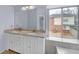 Bathroom featuring a double vanity and a view to the backyard at 560 Woodstone Rd, Lithonia, GA 30058