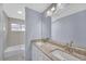 Bright bathroom with a granite countertop, dual sinks, and a tile backsplash at 560 Woodstone Rd, Lithonia, GA 30058