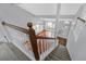 View from the stairs to the foyer with hard wood floors and lots of natural light at 560 Woodstone Rd, Lithonia, GA 30058