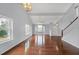 Open floor plan featuring hardwood floors, a staircase, and a view of the living area with large windows at 560 Woodstone Rd, Lithonia, GA 30058