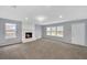 Bright living room featuring a fireplace and large windows at 560 Woodstone Rd, Lithonia, GA 30058