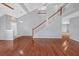 Living room featuring hardwood floors, a staircase leading to the second level, and a modern light fixture at 560 Woodstone Rd, Lithonia, GA 30058