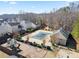 Aerial view of a community pool, playground, and surrounding wooded area at 79 Greystone Way, Hiram, GA 30141