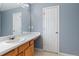 Bathroom with a white sink, wooden cabinet and white door at 79 Greystone Way, Hiram, GA 30141