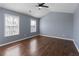 Bedroom featuring hardwood floors, ceiling fan, and two windows at 79 Greystone Way, Hiram, GA 30141