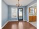 Dining room with backyard access, chandelier, light blue paint, and hardwood floors at 79 Greystone Way, Hiram, GA 30141