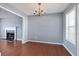 Elegant dining room featuring a decorative chandelier and a seamless flow into the living area at 79 Greystone Way, Hiram, GA 30141