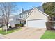 Street view of home featuring manicured landscaping, a driveway, and a two-car garage at 79 Greystone Way, Hiram, GA 30141