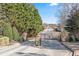 View of the community's gated entrance with lush landscaping at 79 Greystone Way, Hiram, GA 30141