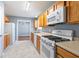 Functional kitchen featuring white appliances, wooden cabinetry, and neutral countertops at 79 Greystone Way, Hiram, GA 30141