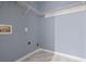 Laundry room with grey walls, wire shelves, and hookups at 79 Greystone Way, Hiram, GA 30141