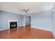 Spacious living room with hardwood floors, a fireplace, ceiling fan and fresh paint at 79 Greystone Way, Hiram, GA 30141