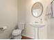 Elegant powder room with a pedestal sink, oval mirror, and modern fixtures at 247 Cavendar Way # 17, Marietta, GA 30066