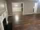 Open-concept living room featuring hardwood floors, a fireplace, and seamless flow to the dining area at 3999 Riverside Pkwy, Decatur, GA 30034